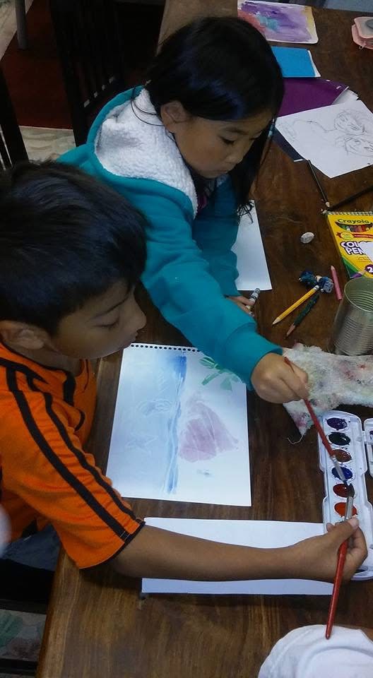 Young students working with watercolors