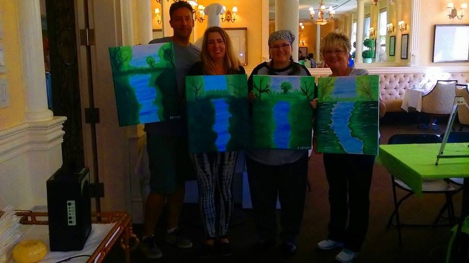 Painting workshop participants showing their finished artwork