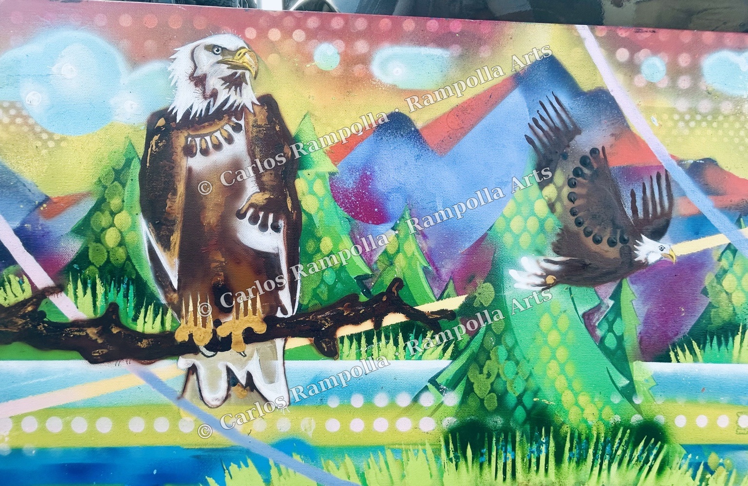 Progress detail of a perched bald eagle and an eagle in flight among mountains and evergreen trees.