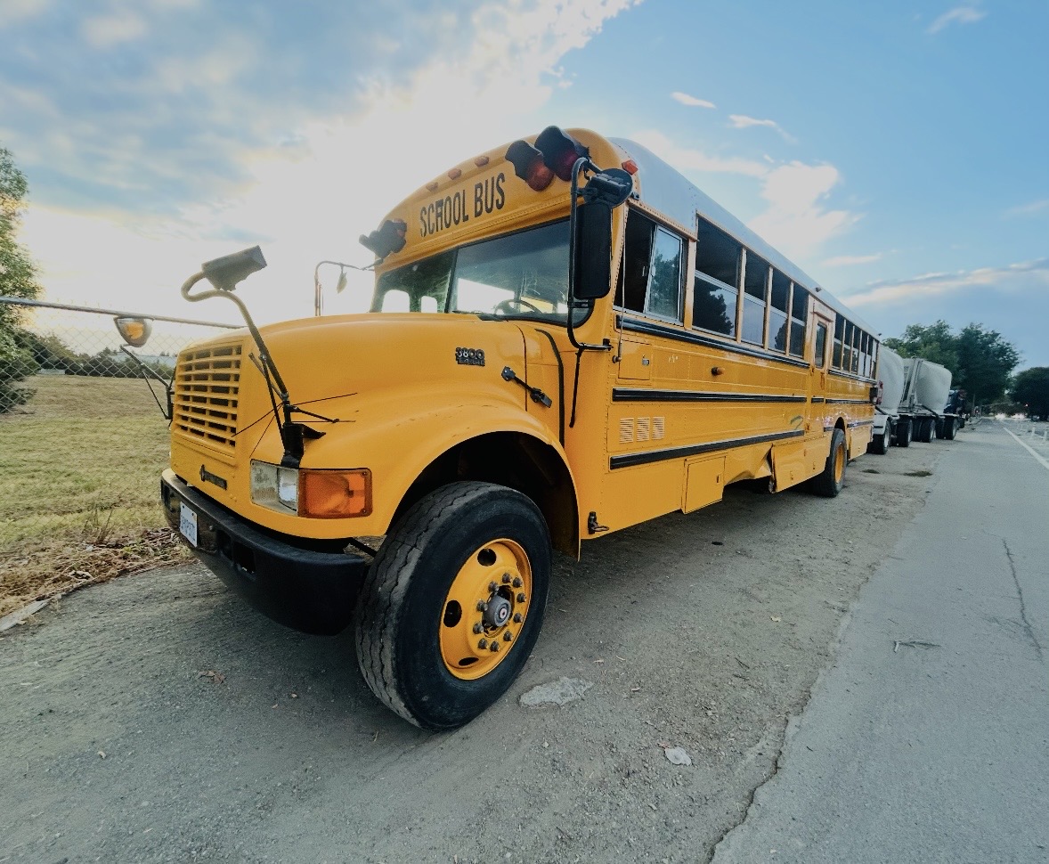 Front and side view of the yellow school bus before its mobile studio conversion.