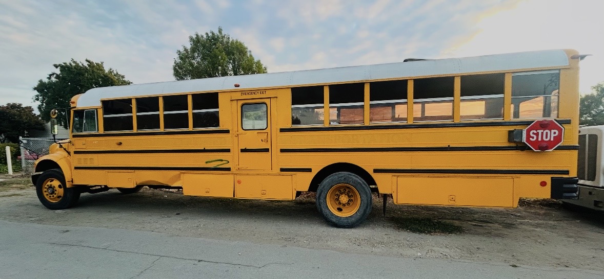 Full side view of the yellow school bus for the Mobile Work Studio project.